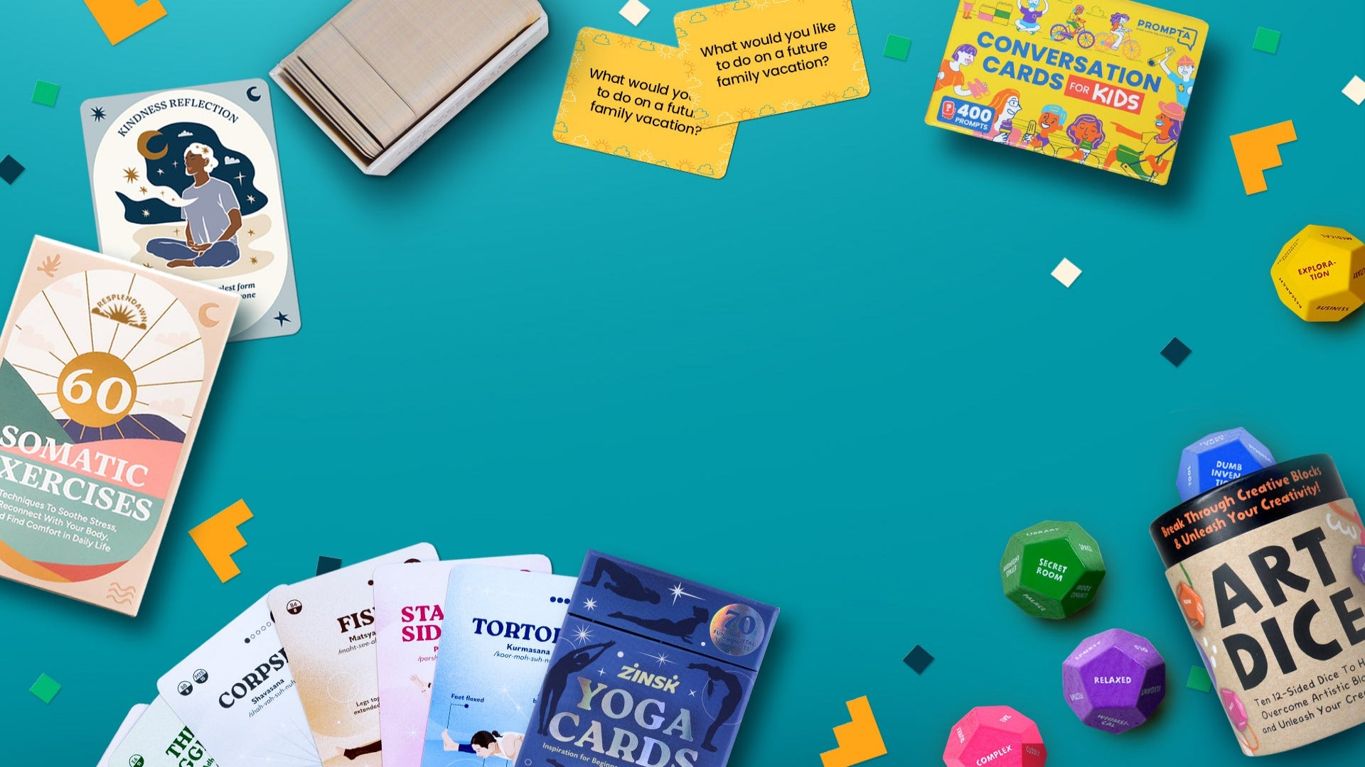 A styled flat-lay of multiple family and self-care themed cards, dice, and a yoga card deck arranged on a bright teal background with confetti accents. Visible items include a '60 Somatic Exercises' card deck, 'Conversation Cards for Kids', a yoga card deck, art dice, and other colorful game pieces.